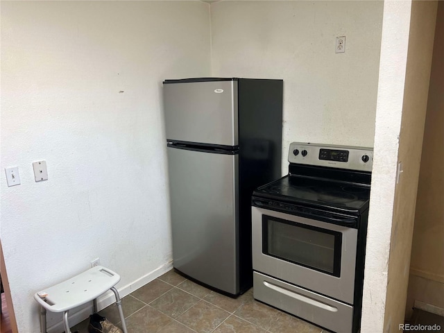 kitchen with light tile patterned floors and stainless steel appliances