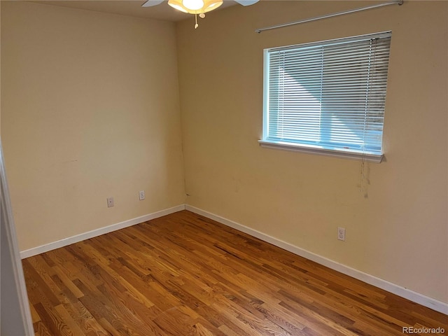 empty room with ceiling fan and wood-type flooring