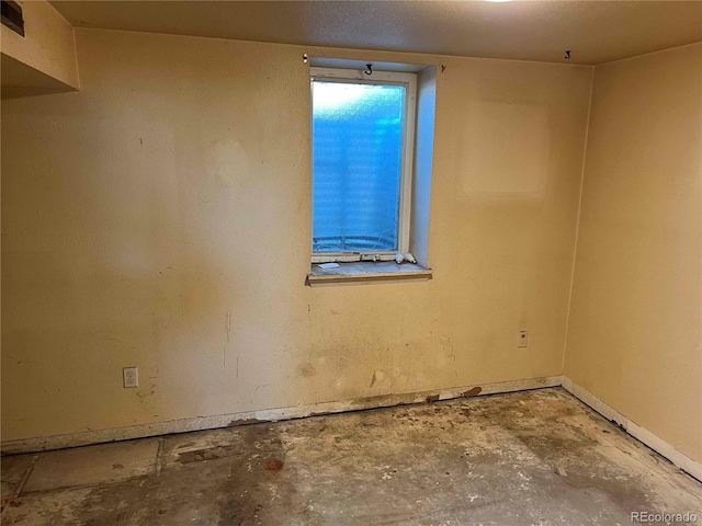 unfurnished room featuring concrete flooring