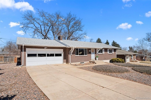 ranch-style home with brick siding, fence, concrete driveway, a chimney, and an attached garage