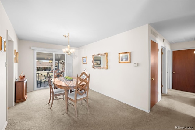 dining space with visible vents, light carpet, and a notable chandelier