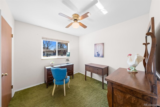 carpeted office featuring a ceiling fan and baseboards