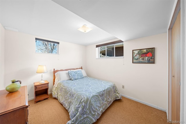 carpeted bedroom with multiple windows and baseboards