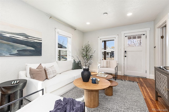 living room featuring a wealth of natural light, a textured ceiling, wood finished floors, and recessed lighting