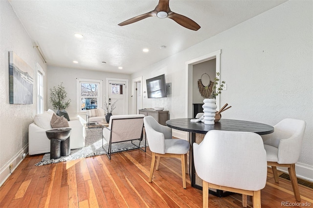 dining area featuring a textured wall, visible vents, and light wood finished floors