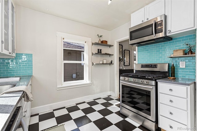 kitchen featuring tile patterned floors, open shelves, white cabinets, and appliances with stainless steel finishes