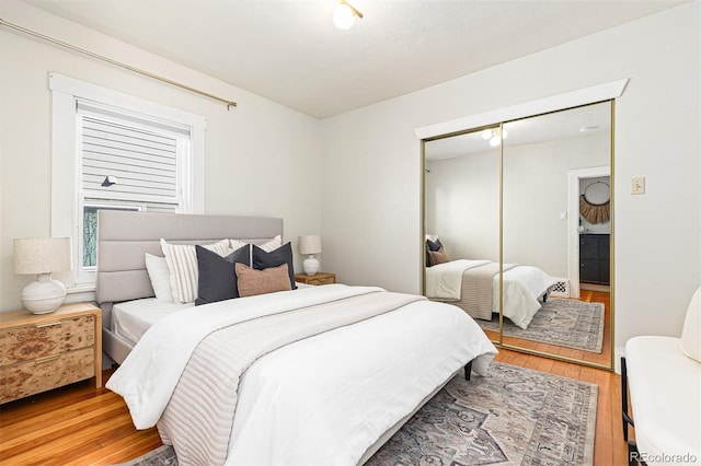 bedroom featuring a closet and light wood-type flooring