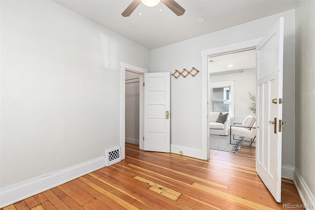 bedroom featuring visible vents, ceiling fan, baseboards, and light wood-style floors