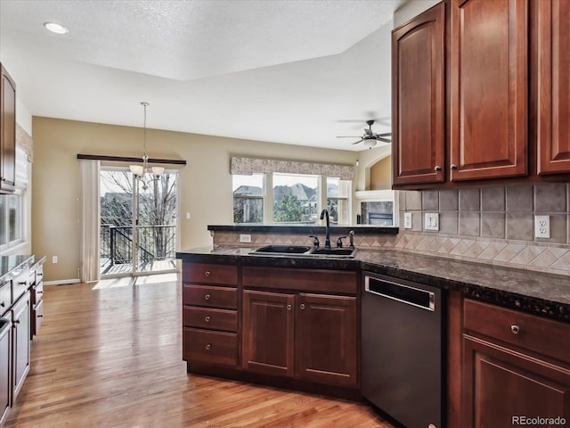 kitchen with decorative backsplash, ceiling fan with notable chandelier, a sink, light wood-style floors, and dishwashing machine