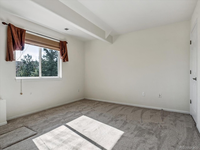 empty room featuring beamed ceiling, baseboards, and carpet