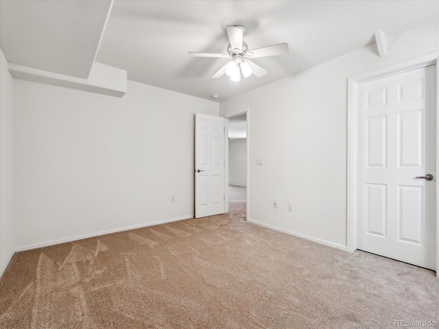 unfurnished bedroom featuring baseboards, carpet floors, and ceiling fan