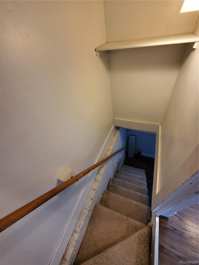 stairway with hardwood / wood-style floors