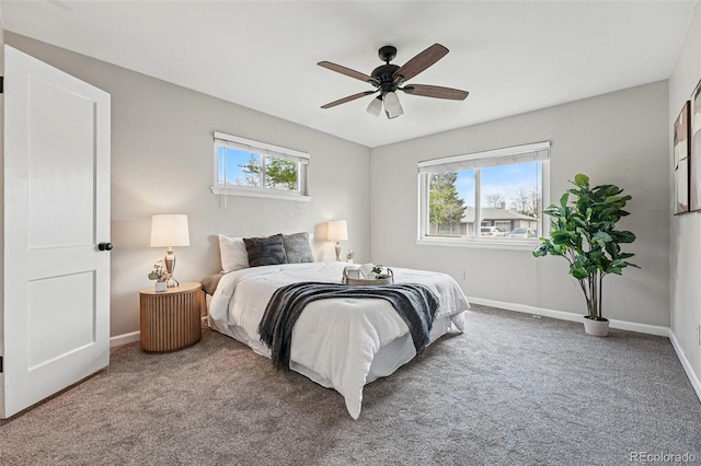 bedroom with carpet floors, baseboards, ceiling fan, and multiple windows