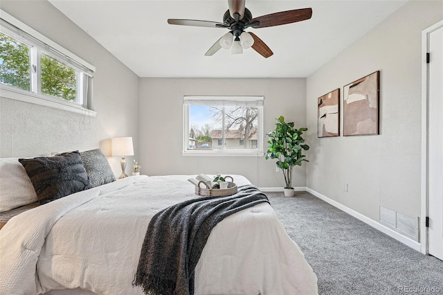 carpeted bedroom featuring visible vents, baseboards, and ceiling fan