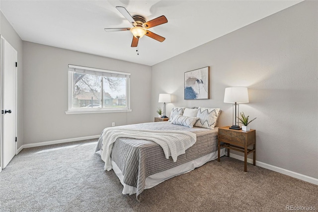 carpeted bedroom featuring baseboards and a ceiling fan