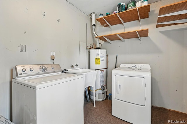 clothes washing area featuring separate washer and dryer, laundry area, a sink, and water heater