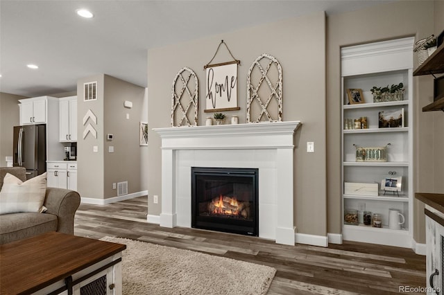 6827 Leilani Ln, Castle Rock, CO 80108 - living area featuring a fireplace, wood finished floors, baseboards, and recessed lighting