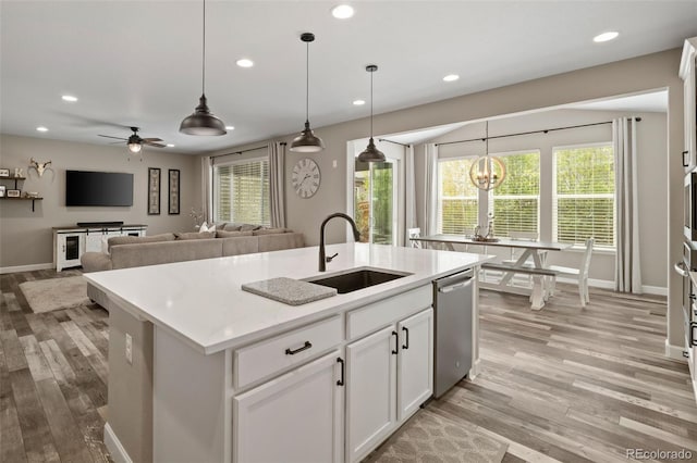 6827 Leilani Ln, Castle Rock, CO 80108 - kitchen featuring a sink, dishwasher, light wood finished floors, recessed lighting, and pendant lighting