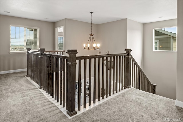 6827 Leilani Ln, Castle Rock, CO 80108 - stairs featuring carpet floors, a chandelier, healthy amount of natural light, and baseboards