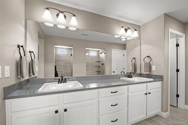 6827 Leilani Ln, Castle Rock, CO 80108 - full bathroom featuring double vanity, a tile shower, and baseboards