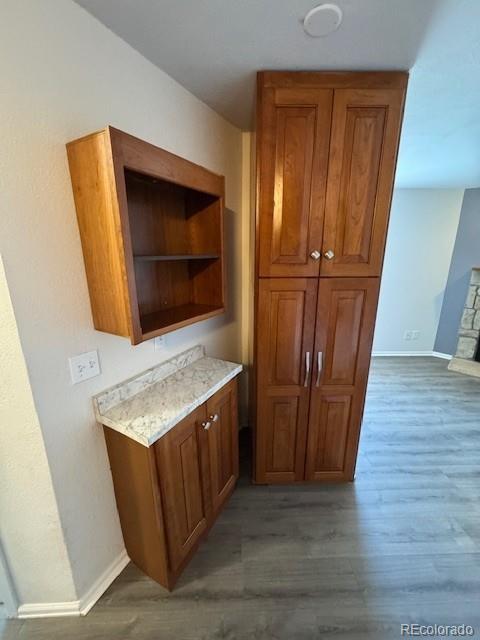 bar featuring wood finished floors and baseboards