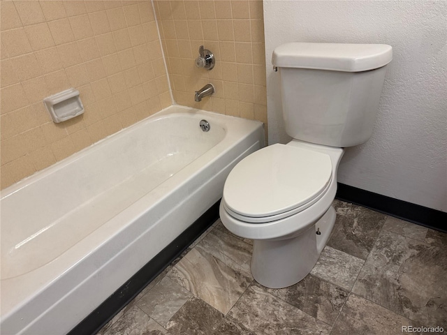 bathroom with toilet and baseboards