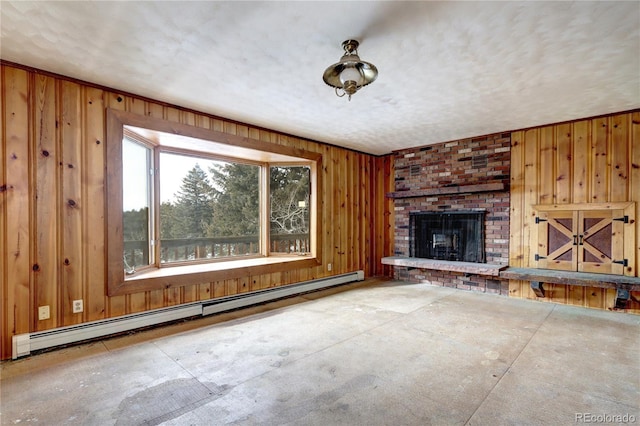 unfurnished living room with a brick fireplace, a baseboard radiator, and a textured ceiling