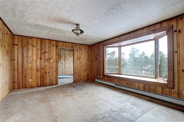 spare room featuring a baseboard radiator and a textured ceiling