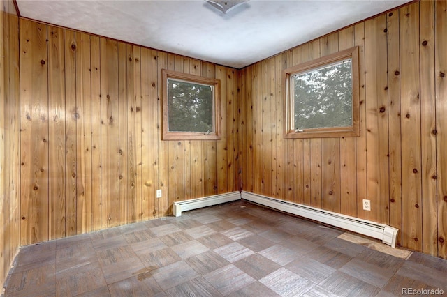 empty room with wooden walls and a baseboard radiator