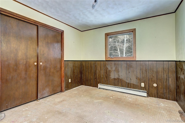 interior space featuring a baseboard heating unit and a textured ceiling