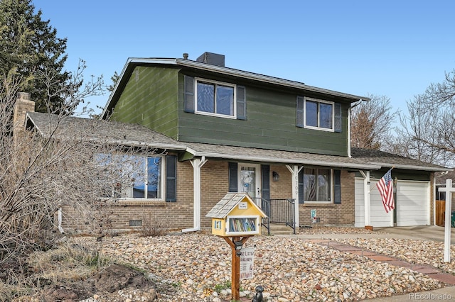 traditional home featuring roof with shingles, an attached garage, covered porch, a chimney, and brick siding