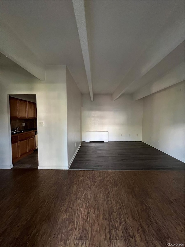 364 S Ironton St Unit 217, Aurora, CO 80012 - unfurnished room featuring dark wood-style flooring and beamed ceiling