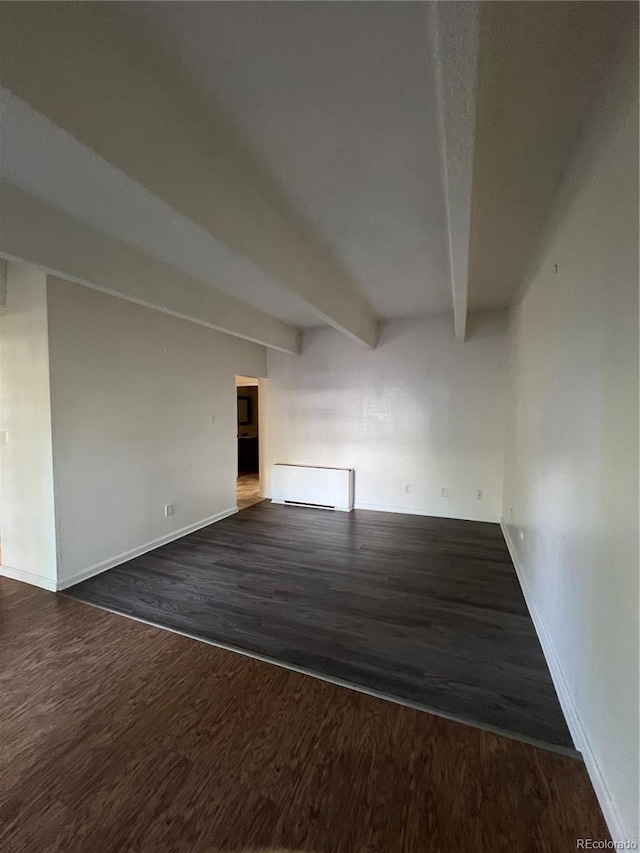 364 S Ironton St Unit 217, Aurora, CO 80012 - unfurnished room with dark wood-style floors, beamed ceiling, and radiator