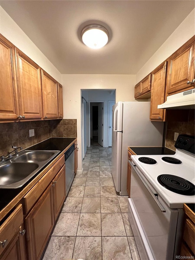 364 S Ironton St Unit 217, Aurora, CO 80012 - kitchen with white appliances, under cabinet range hood, decorative backsplash, and dark countertops