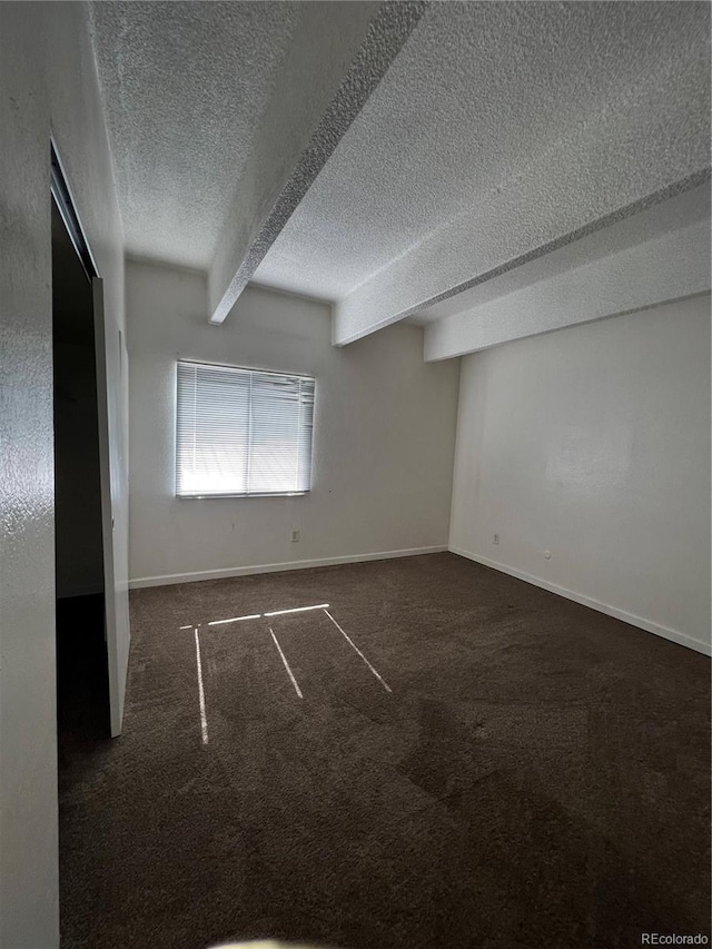364 S Ironton St Unit 217, Aurora, CO 80012 - spare room with a textured ceiling, carpet floors, and beamed ceiling
