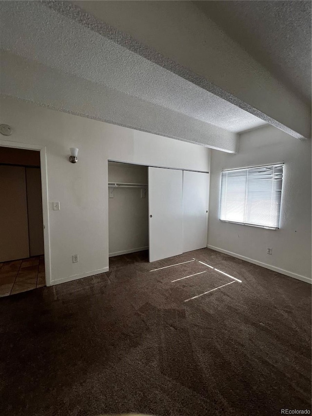 364 S Ironton St Unit 217, Aurora, CO 80012 - unfurnished bedroom with a textured ceiling, carpet floors, and a closet