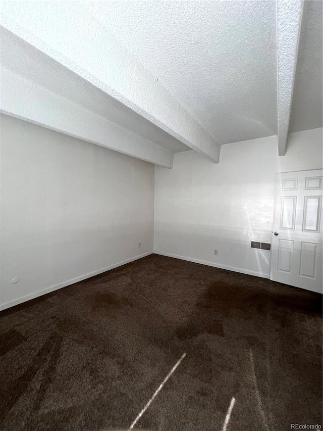 364 S Ironton St Unit 217, Aurora, CO 80012 - spare room with carpet flooring, a textured ceiling, and beamed ceiling