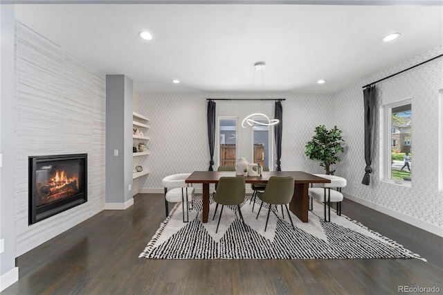 dining area featuring dark hardwood / wood-style floors and a tile fireplace