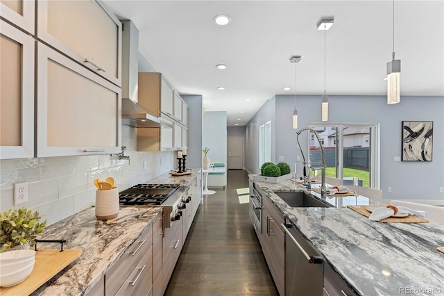 kitchen with light stone countertops, tasteful backsplash, stainless steel appliances, decorative light fixtures, and dark hardwood / wood-style floors