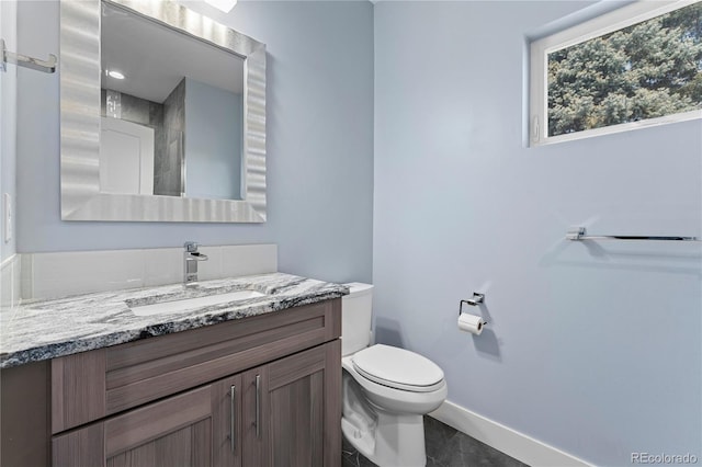 bathroom featuring tile patterned floors, vanity, and toilet