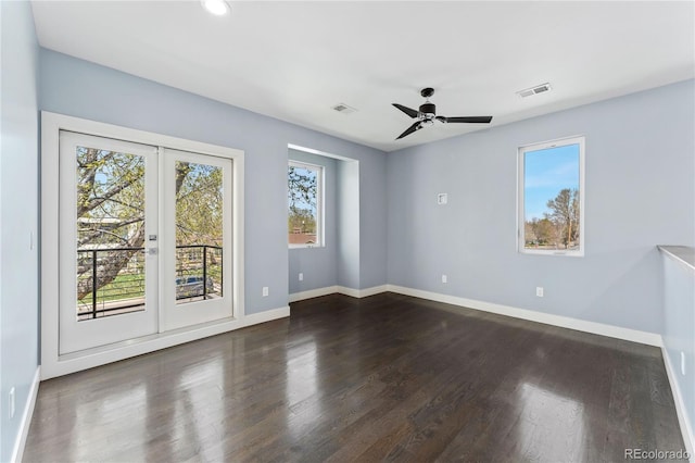 empty room with ceiling fan and dark hardwood / wood-style flooring