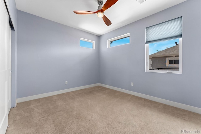 carpeted empty room featuring ceiling fan