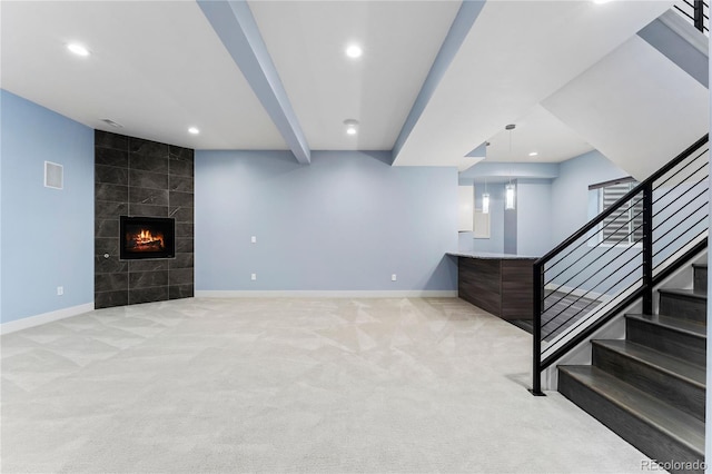 basement with light carpet and a tile fireplace