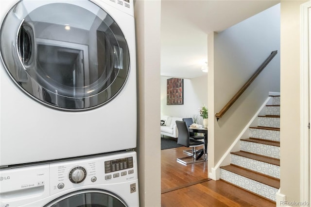 2645 S Xanadu Way Unit D, Aurora, CO 80014 - washroom featuring stacked washer / drying machine and wood finished floors