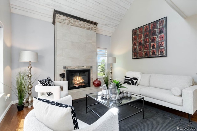 2645 S Xanadu Way Unit D, Aurora, CO 80014 - living area featuring vaulted ceiling, a tile fireplace, and wood finished floors