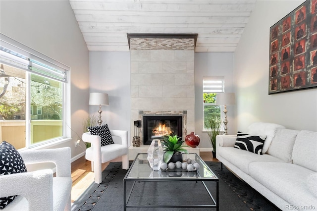 2645 S Xanadu Way Unit D, Aurora, CO 80014 - living area featuring wood finished floors, vaulted ceiling, and a fireplace
