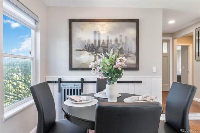 2645 S Xanadu Way Unit D, Aurora, CO 80014 - dining space featuring wainscoting and plenty of natural light