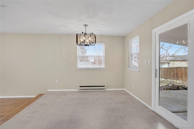 unfurnished dining area with a baseboard heating unit, a chandelier, and baseboards