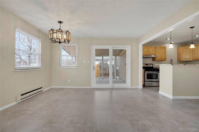 unfurnished living room with baseboard heating, a chandelier, baseboards, and a sink