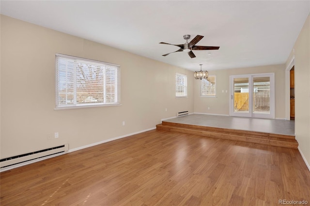15650 E Eldorado Dr, Aurora, CO 80013 - spare room with a ceiling fan, light wood-style floors, a chandelier, baseboards, and a baseboard radiator